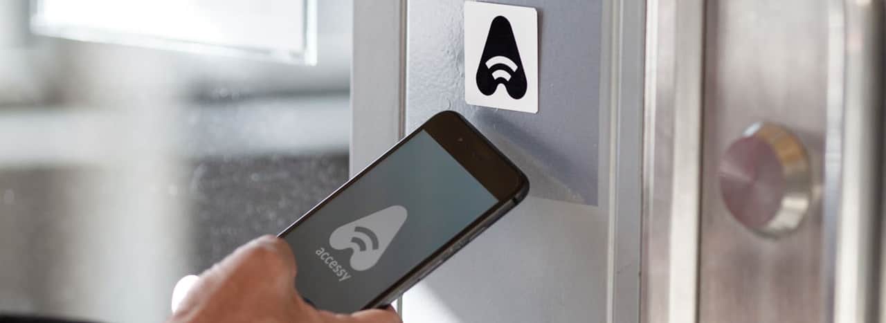 Person som öppnar dörr med sin telefon.