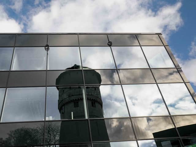 Torn som avspeglar sig i fastighetens fasad.