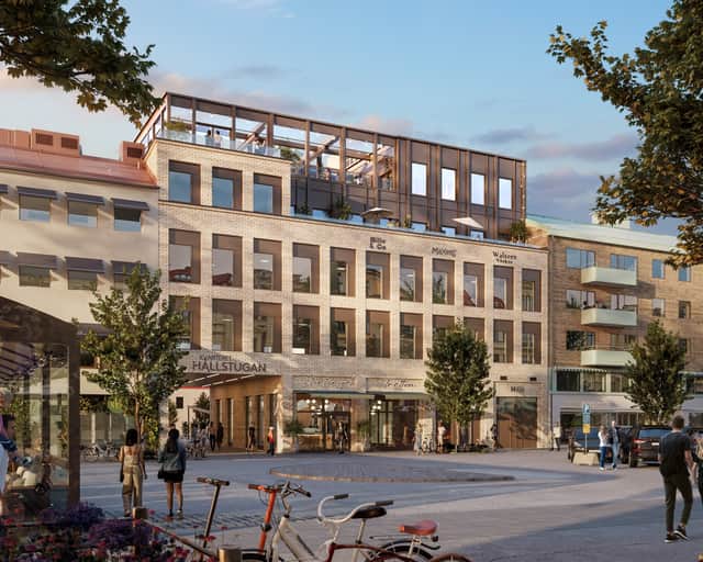 Det nya kontorshuset i ljust tegel med restaurang i botten och takterass högst upp